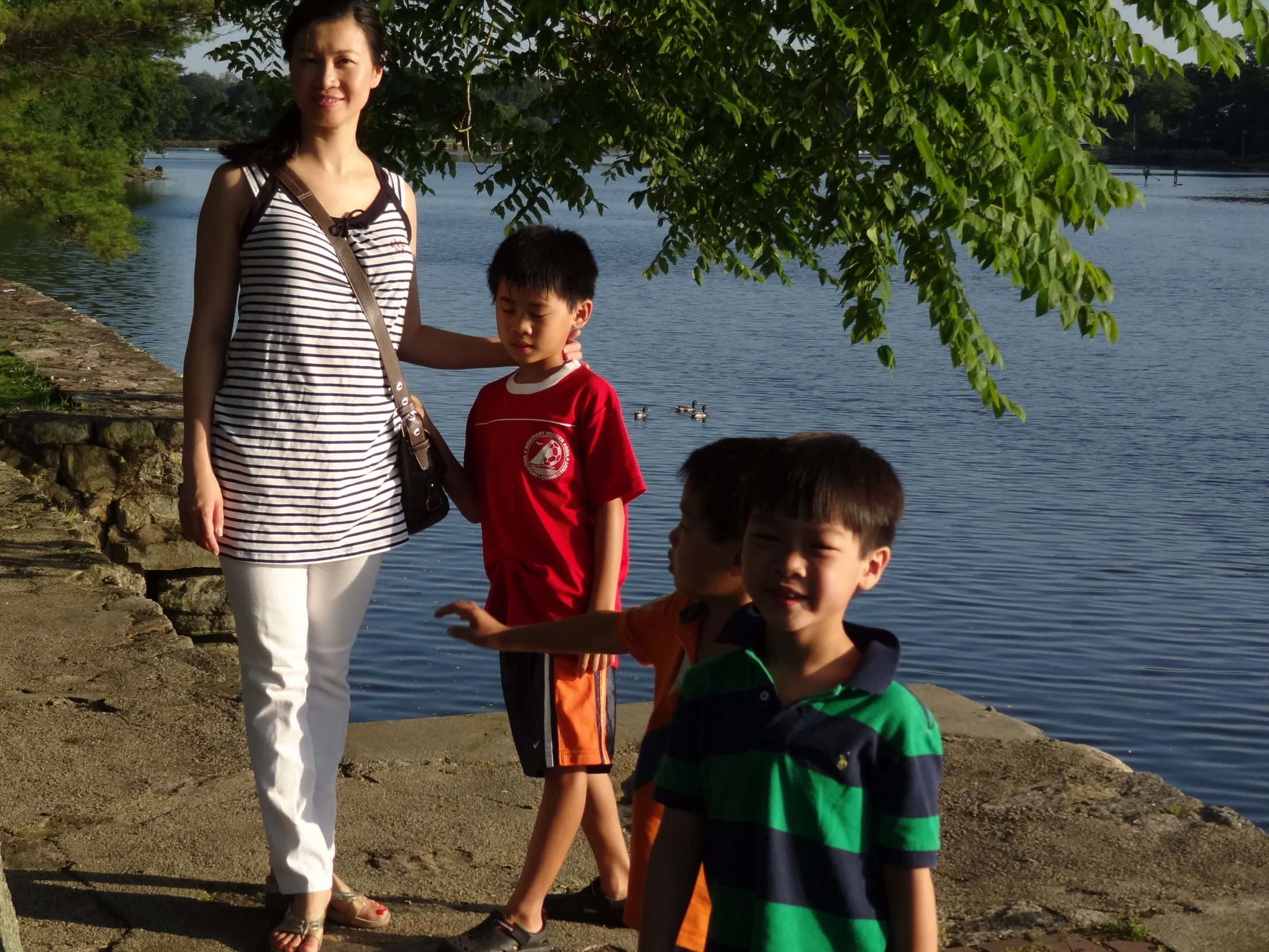 a woman and three children are looking at the camera