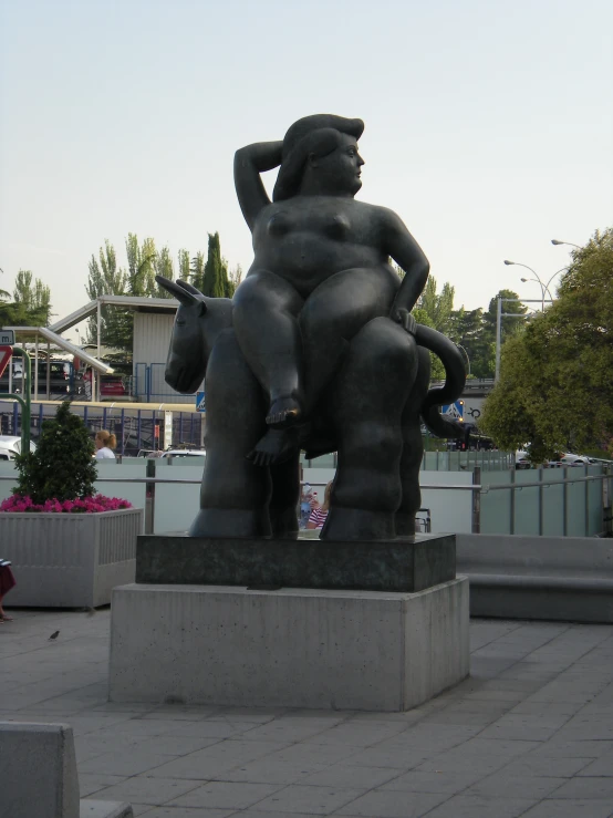 a statue in an area with trees in the background