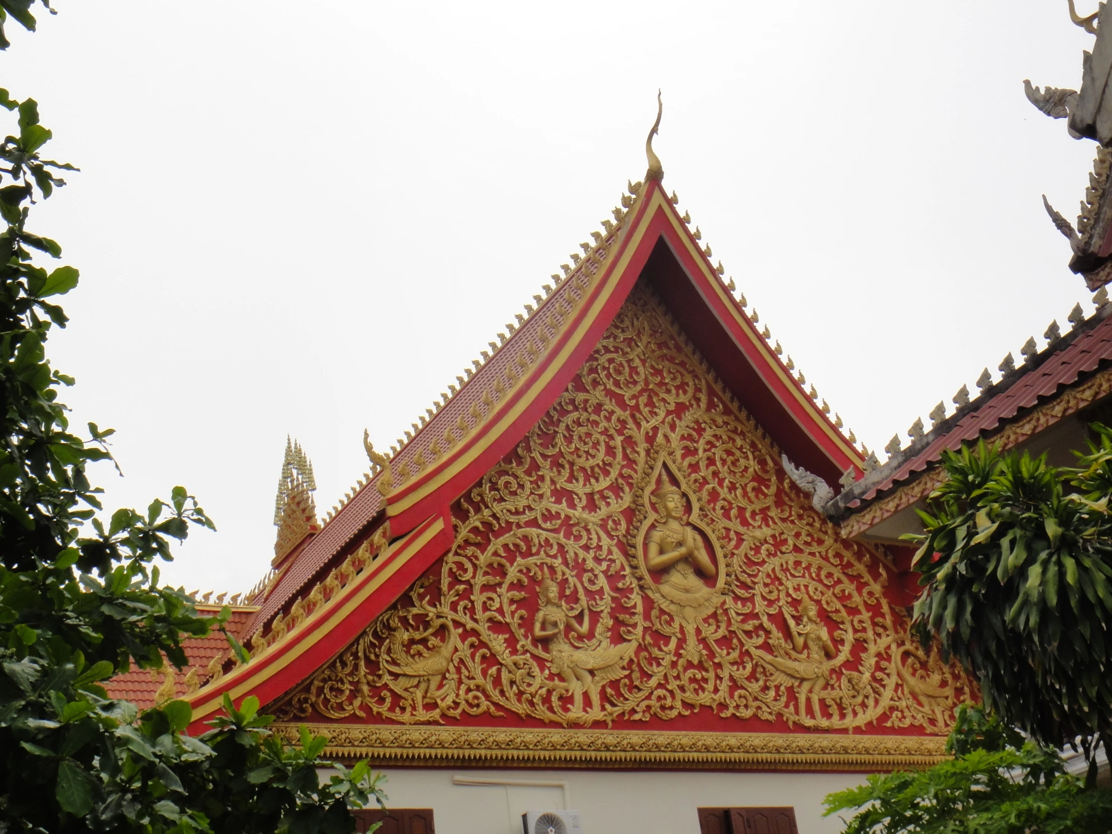 the roof of an elaborate building has decorations on it