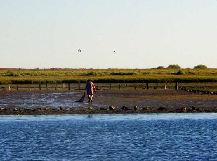 a person walking in the water with a paddle