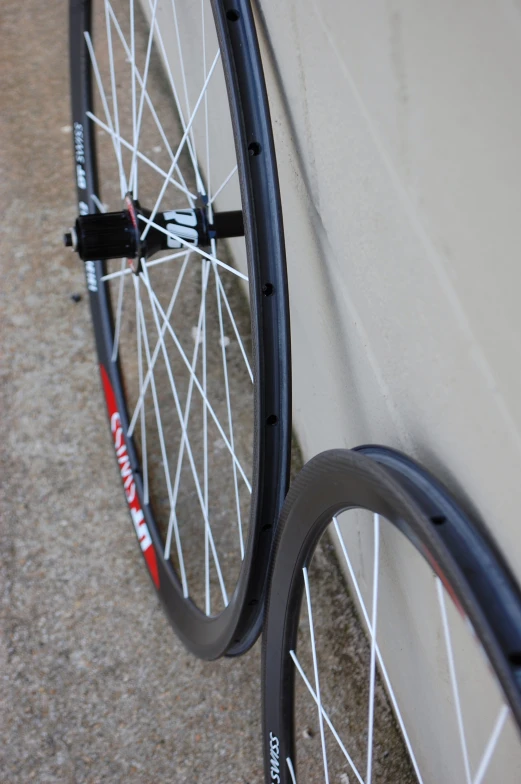 two bicycles wheels, one is black and the other white