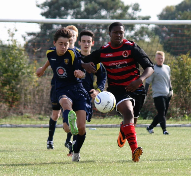 a group of boys playing soccer on a field