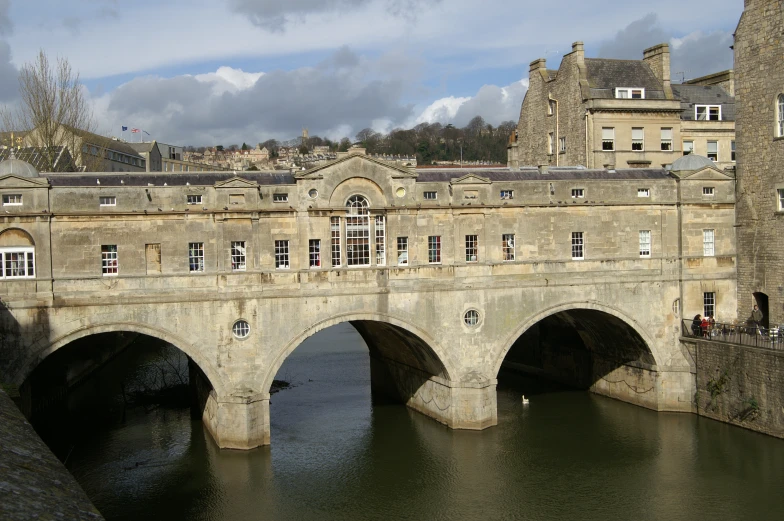 a bridge with a tower on top above the water