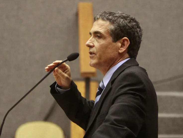 a man stands at a podium and gives a speech