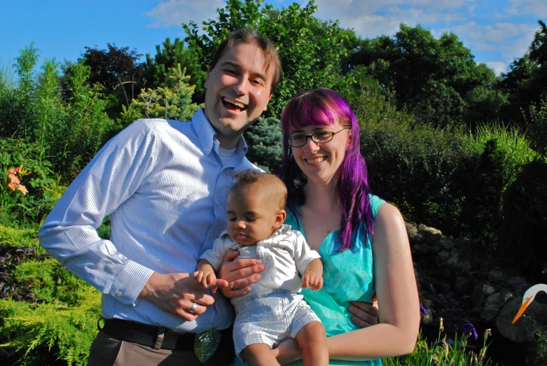 an adult and a baby are posing for a picture