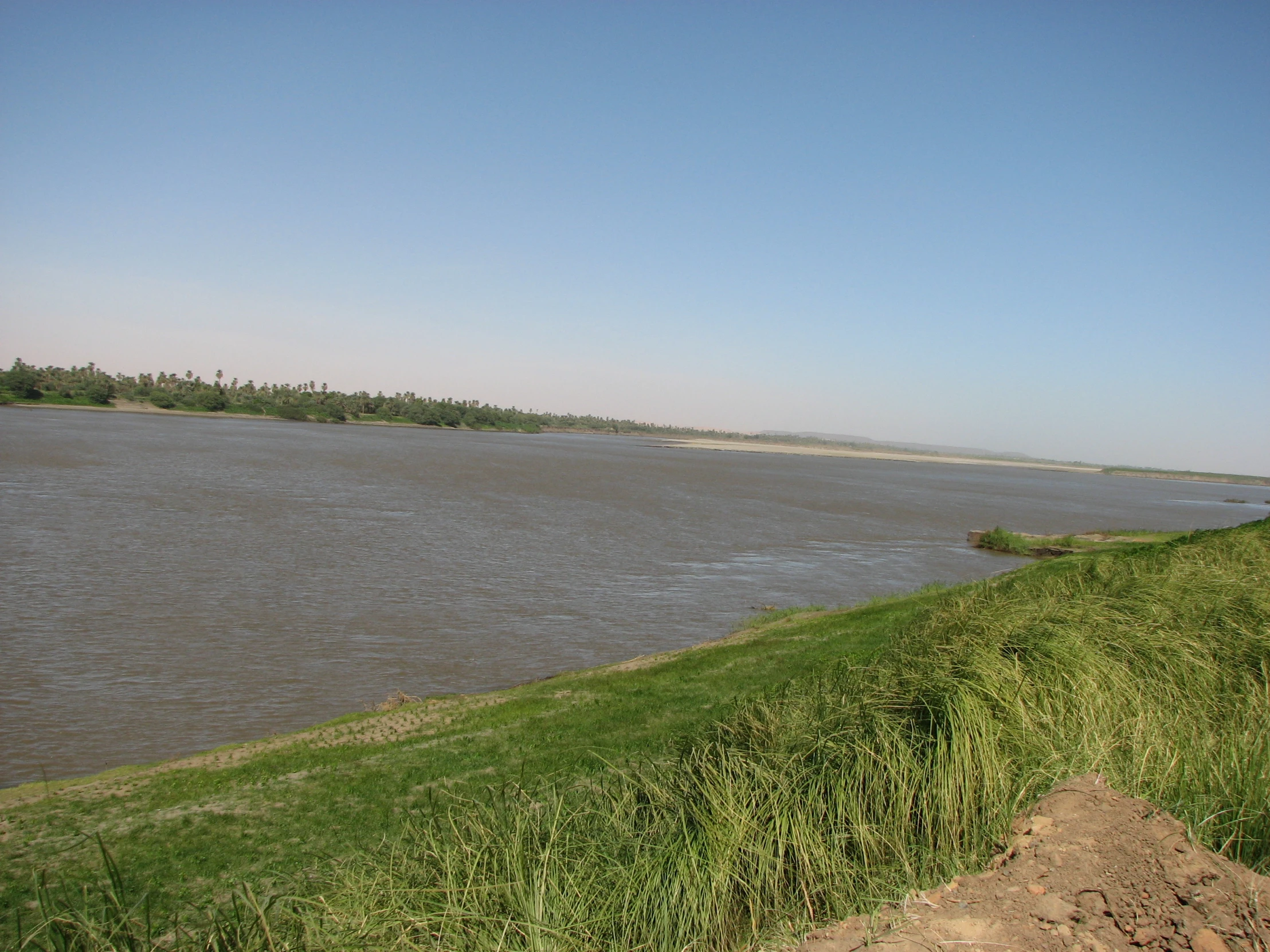 a man standing on the shore of a body of water