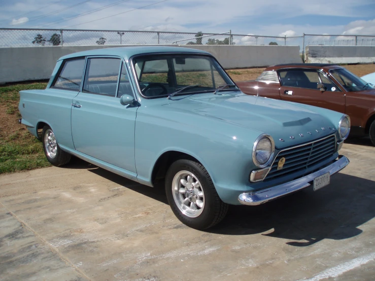 a blue car parked on a paved lot