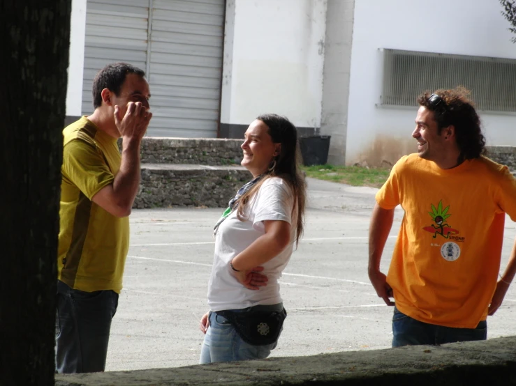 three people standing outside in the sun