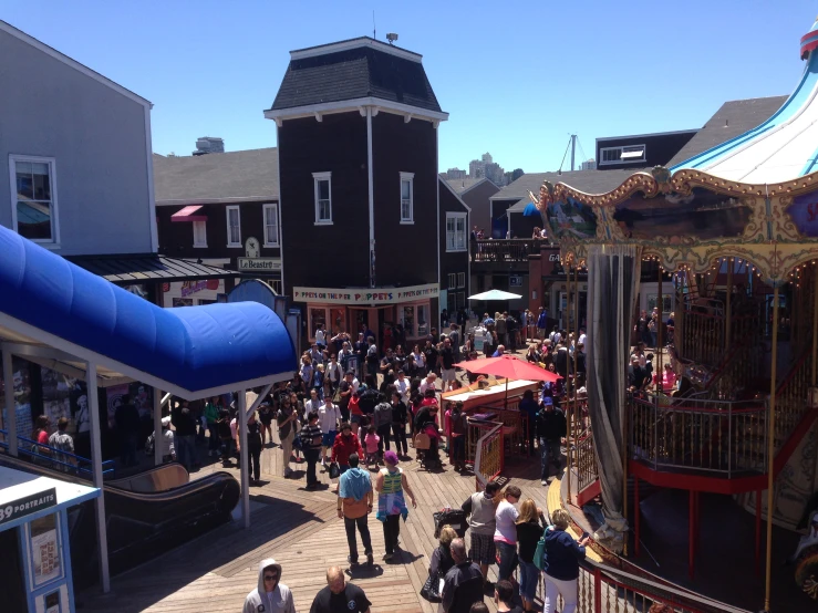 a crowded street with people standing on the sidewalk