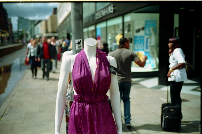 a mannequin is in front of a clothing store