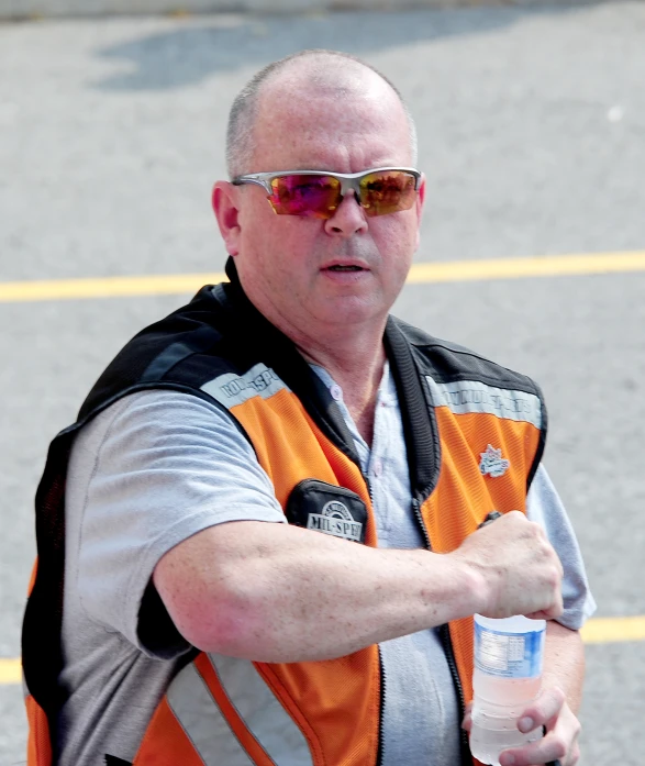 man in sunglasses holding out his hand toward the camera