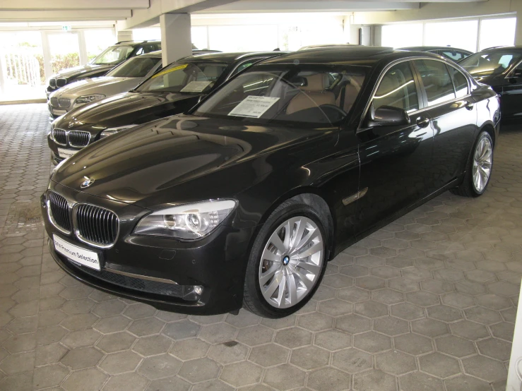 black colored bmw car parked inside of a building