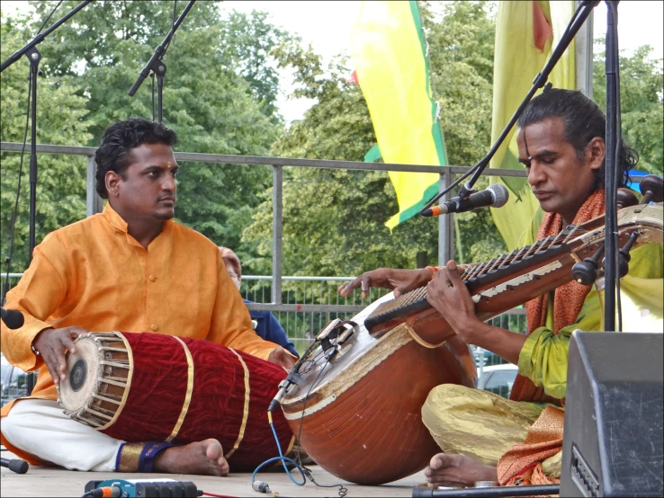 two men playing some kind of musical instrument