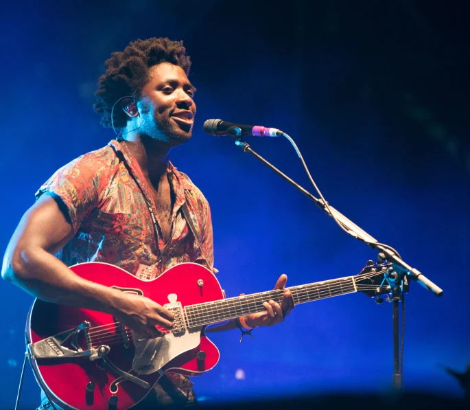 a man that is playing guitar on stage