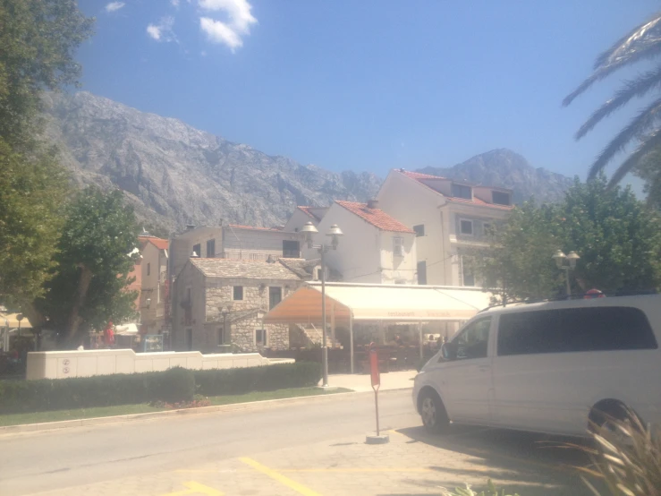 an open street in front of a house and some mountains