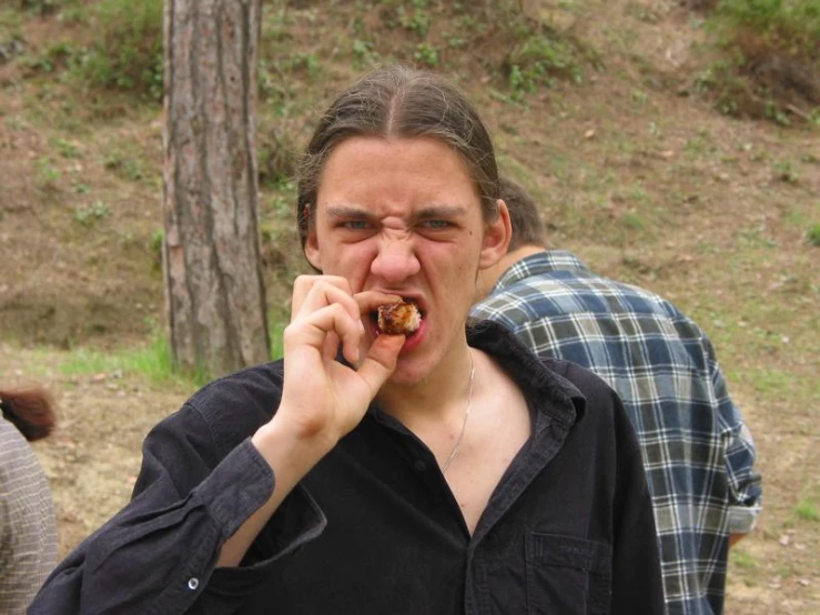 a man eating soing with his mouth wide open