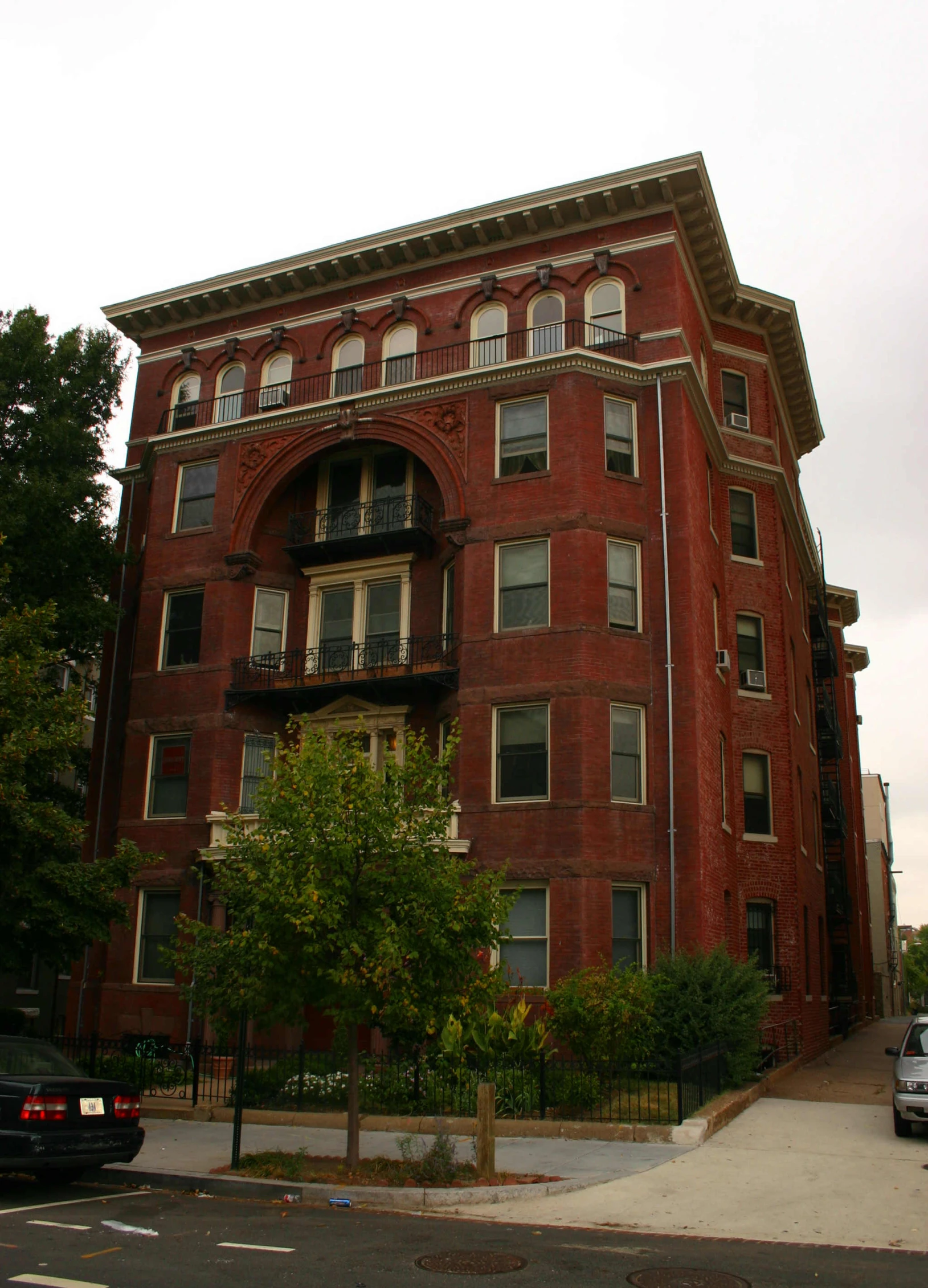 a large red brick building sits on the corner