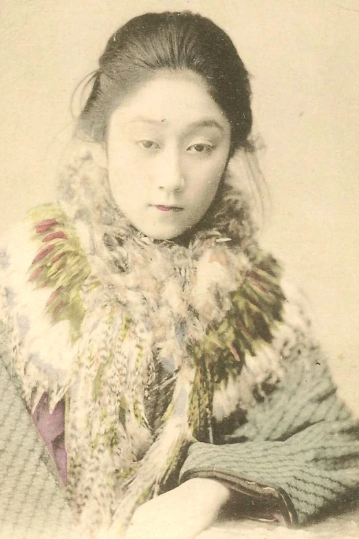 the old pograph shows an asian woman in colorful clothes