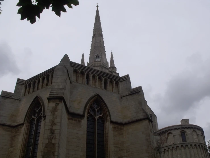 an old church with very large windows and steeples