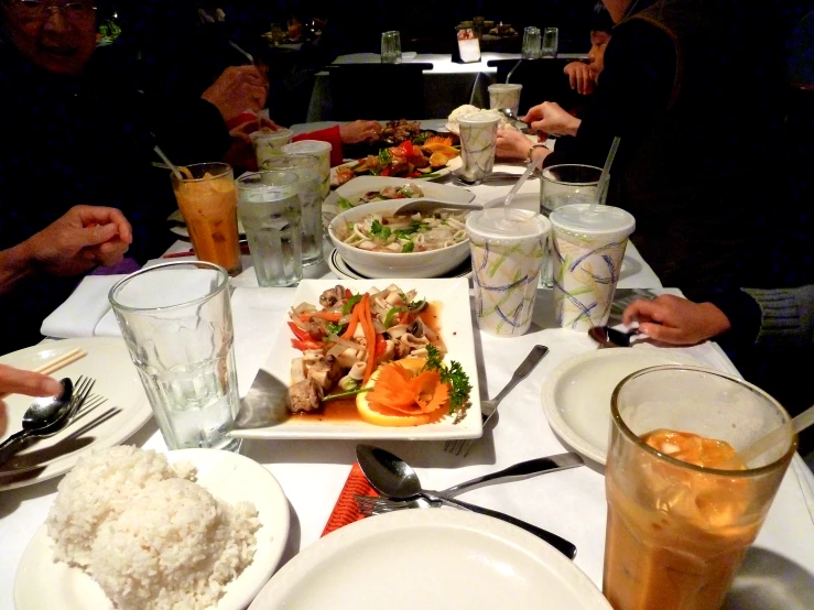 a group of people sit down at a table to eat