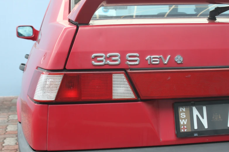 the tail lights of a red car that reads uss 533 / 6