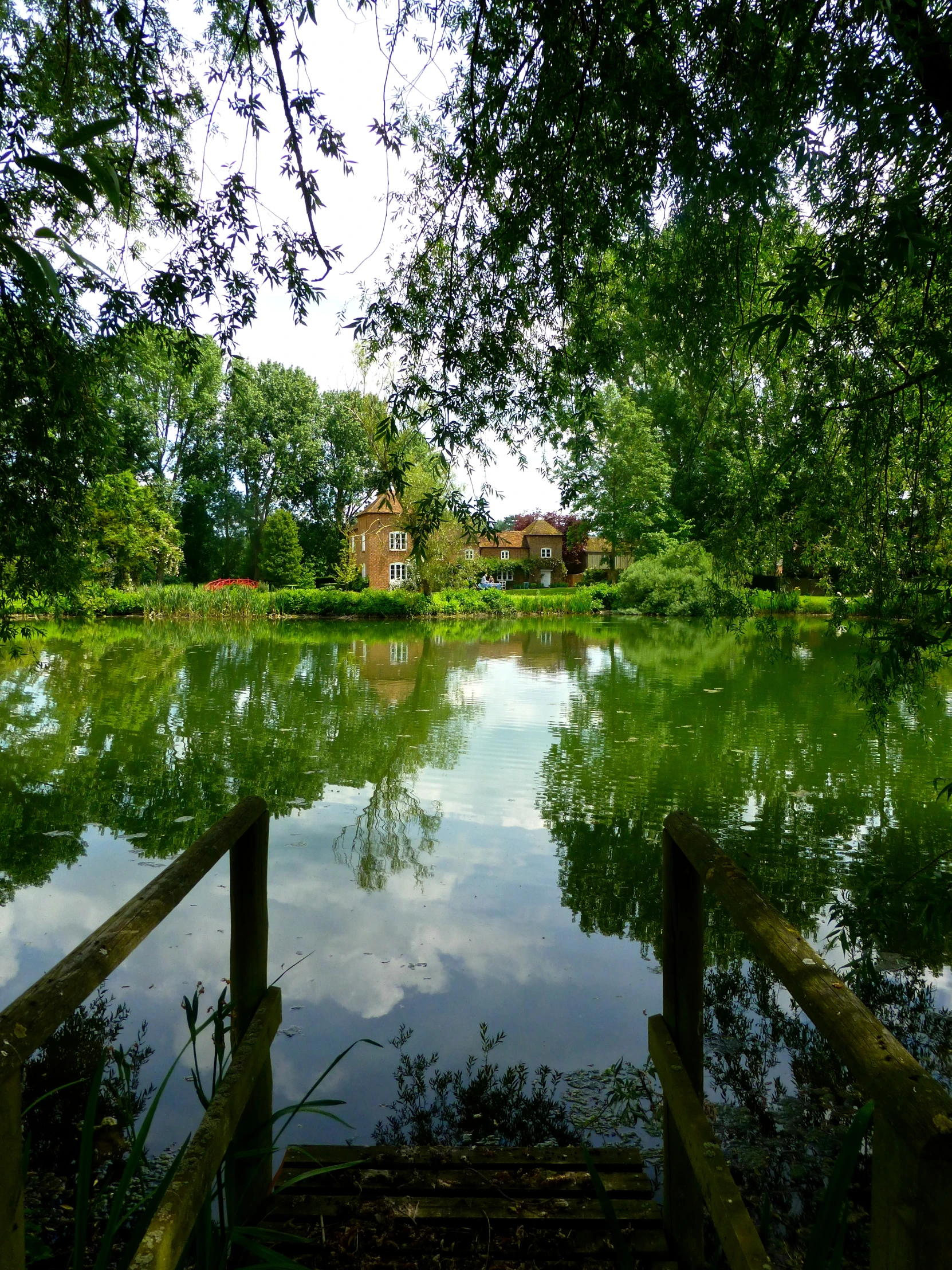 a wooden pier on the side of a lake