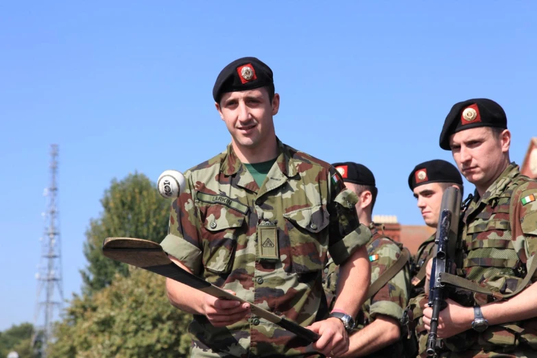 a couple of military men holding weapons in their hands