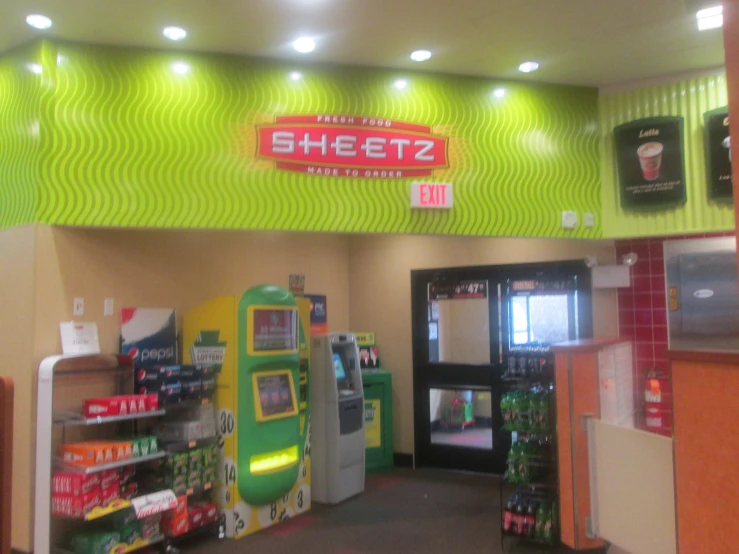 a brightly colored kiosk in the center of a mall