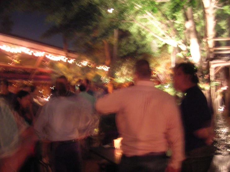 a blurry image shows people walking in a busy area