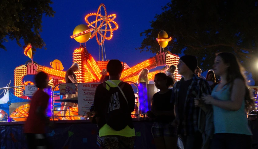 people standing around at night near the amut park