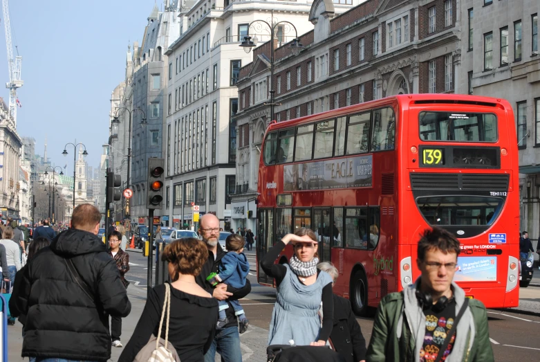 people crossing the street on a busy street