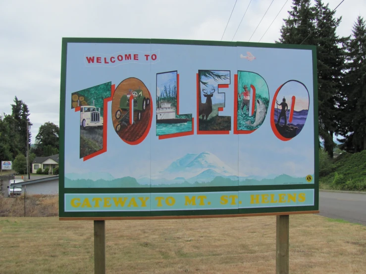 a large welcome sign is displayed on grass