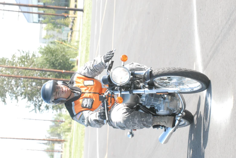 an orange motorcycle is sitting in the road