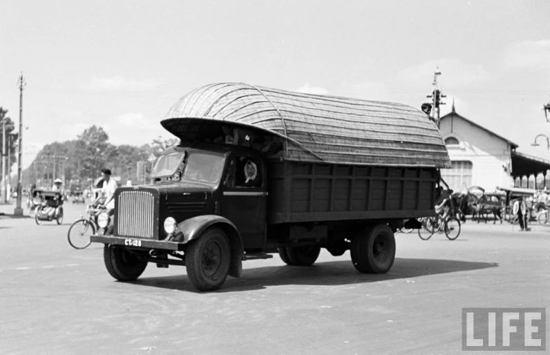 an old pick up truck is carrying a load