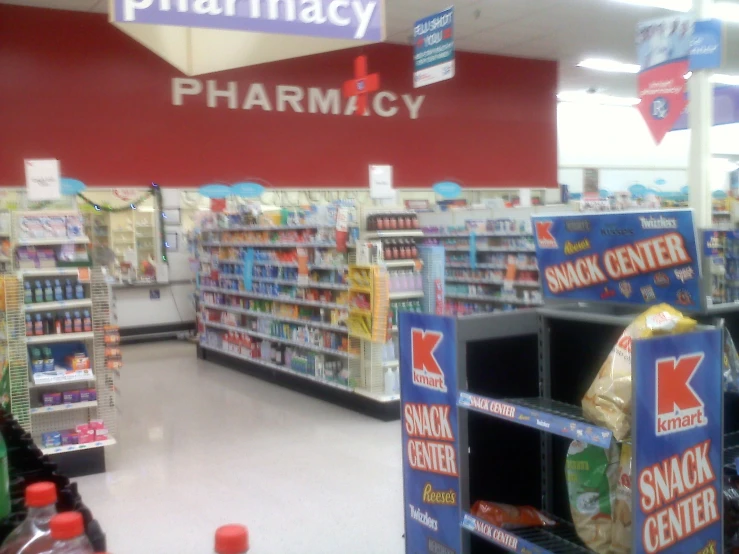 a pharmacy store with a pharmacy sign in the middle