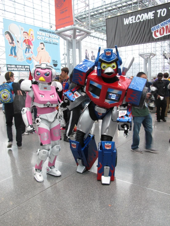 two robot suits are in the middle of a room