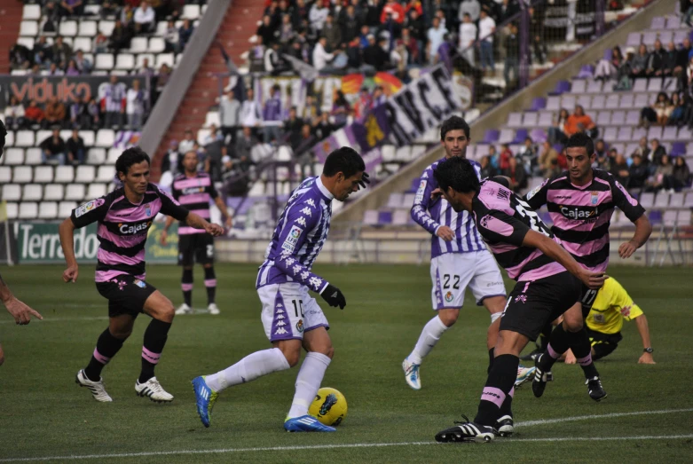 a group of men kicking around a soccer ball