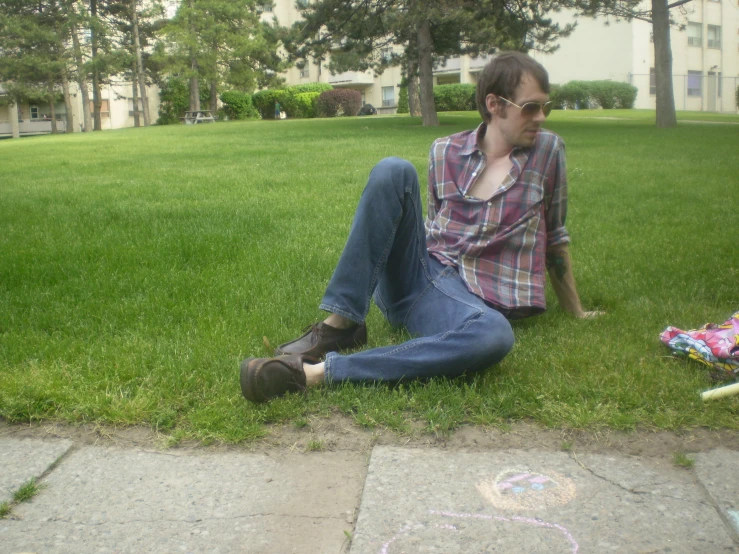 a man sitting on the grass with his mouth open