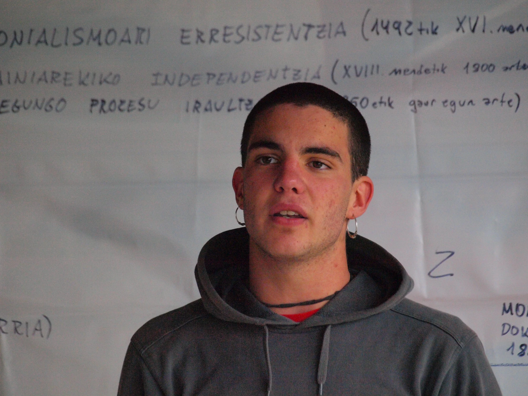 man standing in front of a paper with letters written on it