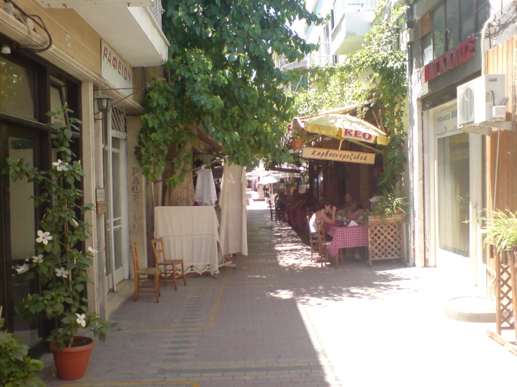 an image of people outside a restaurant in the summer