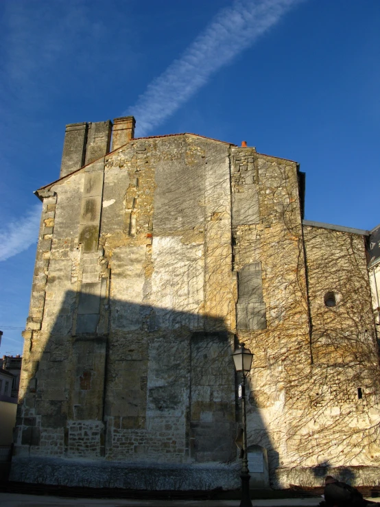 a big stone tower that is on the side of a building