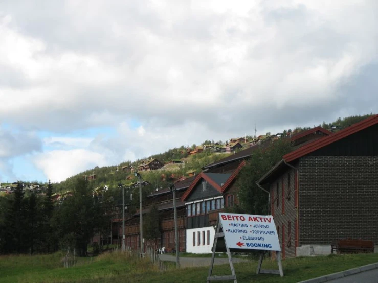 some signs are by a big brown building