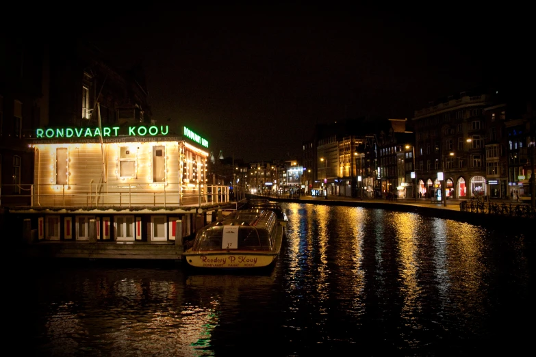 a harbor with a boat docked on it with a sign lit up over the front of it