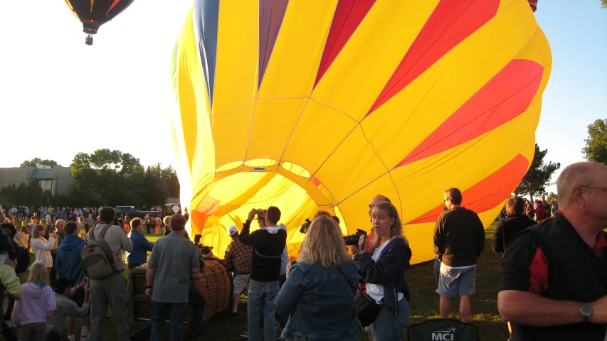people are watching  air balloons take flight
