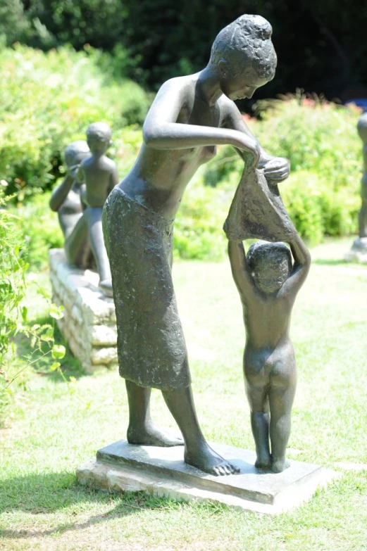 a statue is shown with people holding a planter