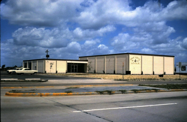 an airplane parked outside of a building with many windows