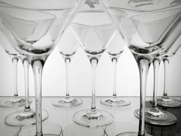 four glasses are set on a table in a row