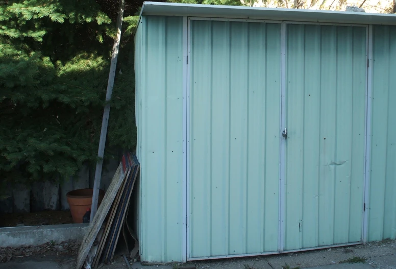 an image of a blue shed that is old and broken