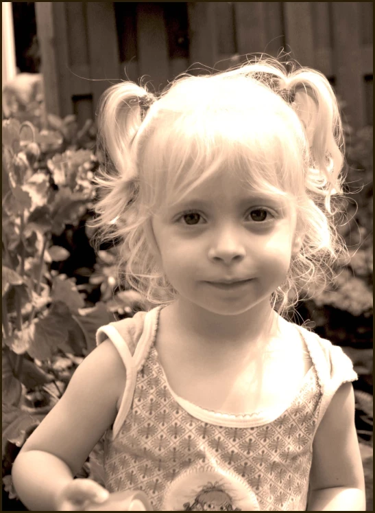 an adorable little girl with pigtails on her head