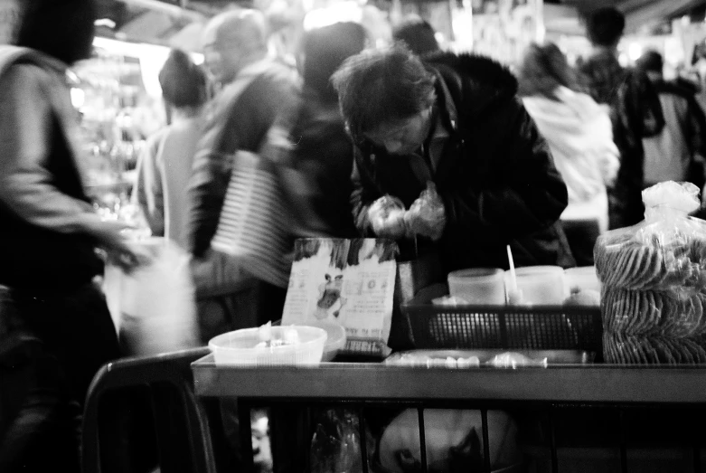 a black and white image of people in a grocery store